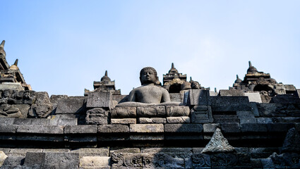 Statue of sitting buddha at Borobudur Temple, spiritual stone sculpture, UNESCO world heritage site