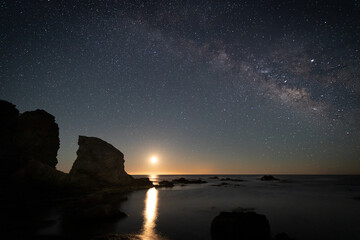 Naklejka na ściany i meble Night landscape with Moon and Milky Way on the coast of the Escullos. Natural Park of Cabo de Gata. Spain.