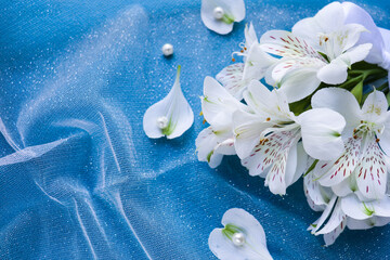 bouquet of white flowers on a blue background and space for text. wedding card. congratulation. invitation