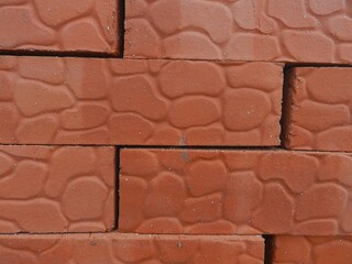 Obraz premium New red bricks. Close-up of their surface.