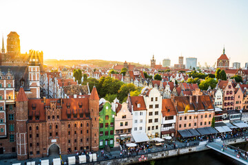 Obraz premium Gdansk, North Poland - August 13, 2020: Panoramic aerial shot of Motlawa river embankment in Old Town during sunset in summer