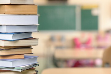 Collection of old books stack on class background