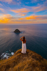 young woman in a white dress on the beach