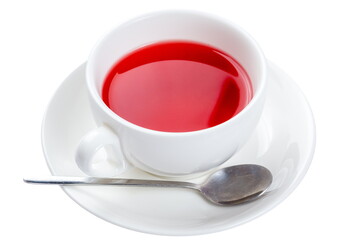 Bright colored fruit tea in a white cup. Isolated on white.