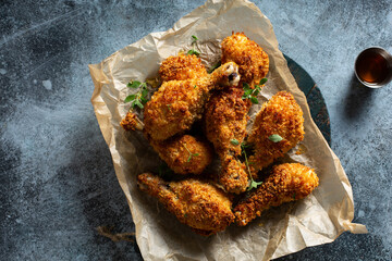 Panko breaded fried chicken drumsticks with hot honey sauce