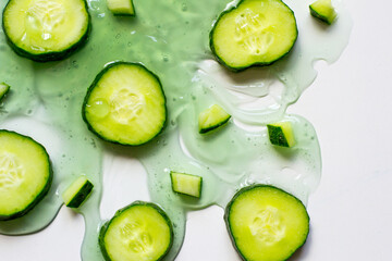 slices of cucumbers on a white plate with gel