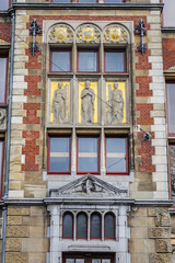 Architectural fragments of Historic building of Amsterdam central railway station. Building of Amsterdam central railway station first opened in 1889. Amsterdam, Netherlands.