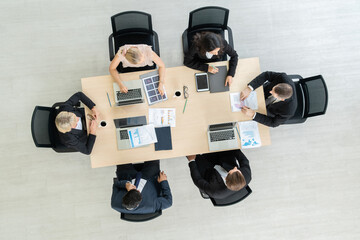 Business people group meeting shot from top view in office . Profession businesswomen, businessmen and office workers working in team conference with project planning document on meeting table . © InfiniteFlow