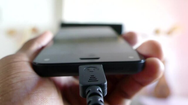 Charging mobile phone with usb cable.
