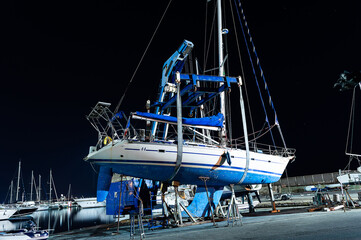 boat lift out of the water by an heavy crane side view