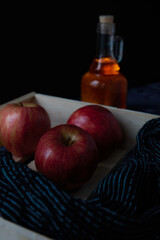 Apples in a wood box an honey in a glass bottle