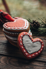 Christmas background with gingerbread cookies and fir branches on the old wooden board. 