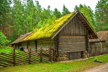 Fototapeta na wymiar Old Latvian wooden house which represents architectural style of the country regions.