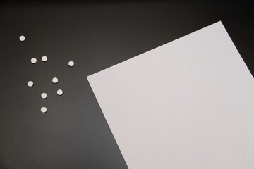 paper and tablets on a black background