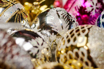 Close-up shot of colorful Christmas Ornaments. Pile of Christmas festive decorations stock photo. Holiday decorations used for hanging on Xmas tree