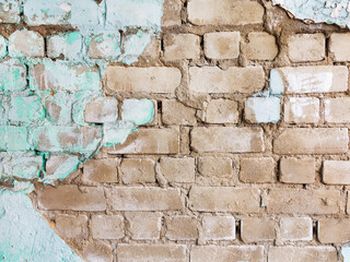 Old brick wall. Remains of plaster and blue paint. As vintage grunge background