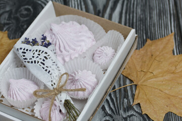 Zephyr in a box, a bouquet of lavender and dried maple leaves. On painted pine planks.