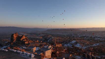 Hot Air Balloons rising in the sky during sunrise in Cappadocia in Göreme, Turkey.