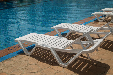 empty beach chairs by the pool