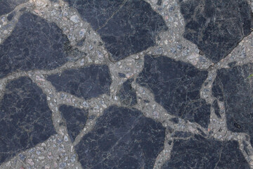 Surface texture with large pieces of marble and small multi-colored stones.