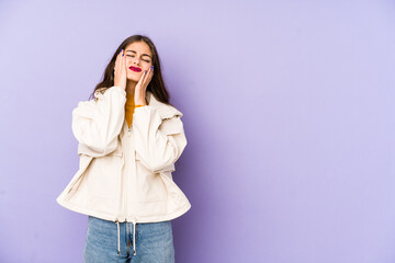 Young caucasian woman isolated on purple background whining and crying disconsolately.