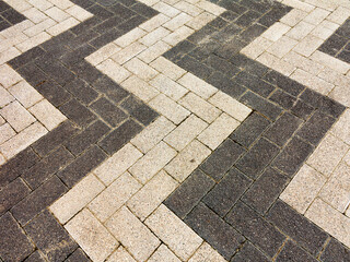 Close-up paving slabs by mosaic. Road paving, construction. Tessellated sidewalk tile. Colored concrete paving slab.