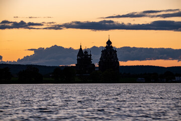 Fototapeta premium ancient churches on the island at sunset on the background of the lake