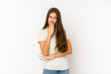 Young caucasian woman isolated on white background yawning showing a tired gesture covering mouth with hand.