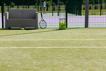 tennis court, tennis racket and tennis balls in the basket