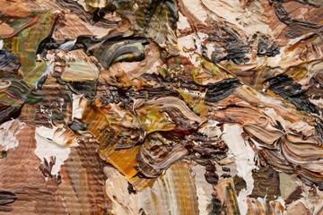 Macro. Abstract art. Expressive embossed pasty oil paints and reliefs. Colors: yellow, white, ocher, brown, green.