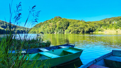 Naklejka na ściany i meble Boat station with lake on background in the summer season