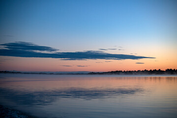 Naklejka premium fog on the lake through green reeds at sunrise