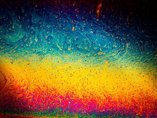Multicolours as light refracts through liquid soap