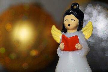 Christmas toy to decorate the Christmas tree. The figure of a singing chorus girl with small wings.