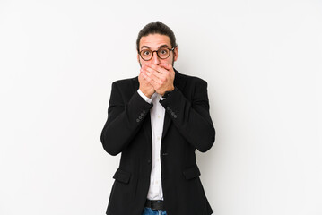 Young caucasian business man isolated on a white background shocked covering mouth with hands.