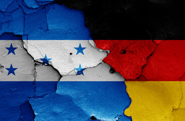 flags of Honduras and Germany painted on cracked wall