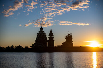 Naklejka premium vintage churches on the island at sunrise on the background of the lake