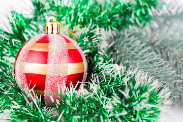 Christmas red, new year ball on the background of a fir branch, selective focus, bokeh