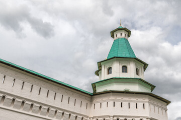Fototapeta na wymiar Stormy sky over the walls of the monastery