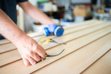 Man's hands holding protective elements for working with wood. Copy space