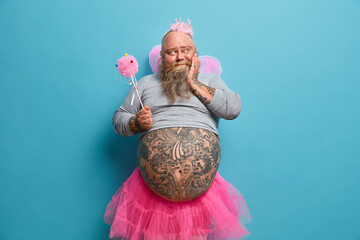 Dreamy man with thick beard, big belly, takes part in cartoon performance, has happy upbringing...