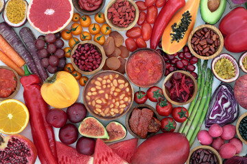 Plant based health food high in lycopene with fruit & vegetables high in antioxidants, anthocyanins, vitamins, carotonoids, minerals, vitamins & dietary fibre. Vegan health care concept. Flat lay. 