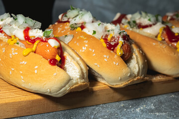 Close up of two hot dogs with sauces