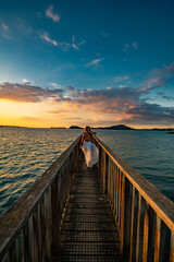 woman on a pier at sunset