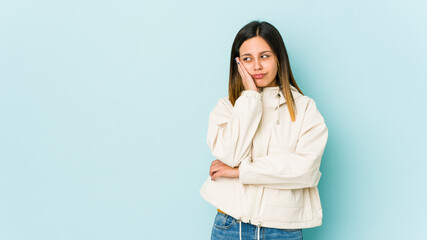 Young woman isolated on blue background who is bored, fatigued and need a relax day.