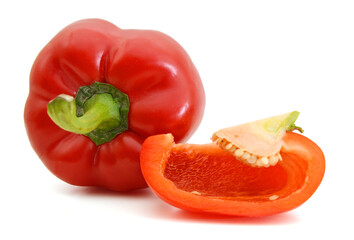 fresh red bell pepper (capsicum) and a cut one on a white background