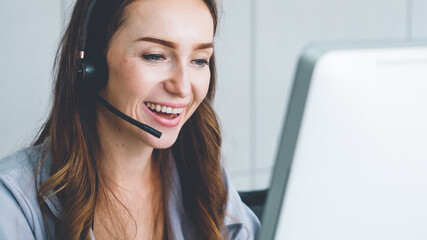 Business people wearing headset working in office to support remote customer or colleague. Call center, telemarketing, customer support agent provide service on telephone video conference call.