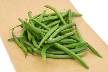 small and slender green beans (haricot vert) on brown paper