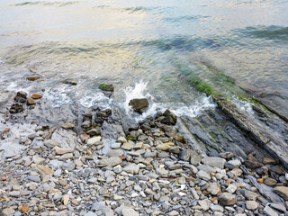 Stones and monolithic mountain slabs under water on sea coast. As background for any your project