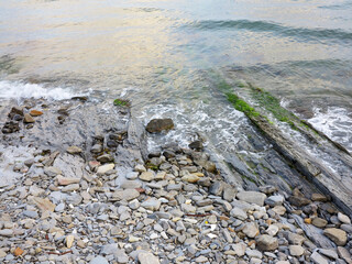 Stones and monolithic mountain slabs under water on sea coast. As background for any your project